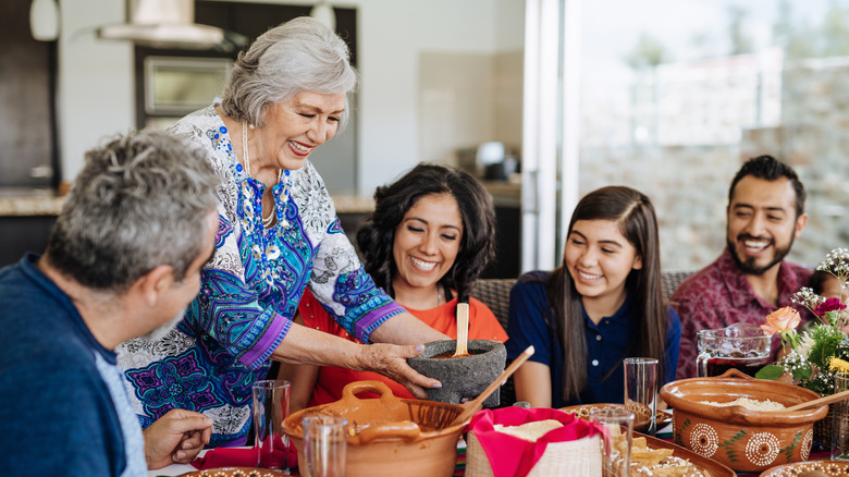 Multi generational family meal with smiles and talking