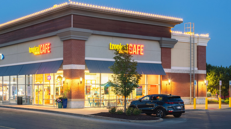 The exterior of a Tropical Smoothie Cafe at dusk