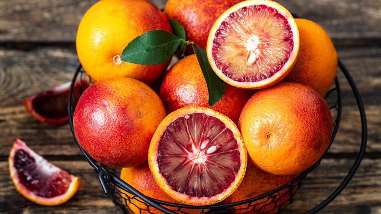 blood oranges in a metal fruit basket