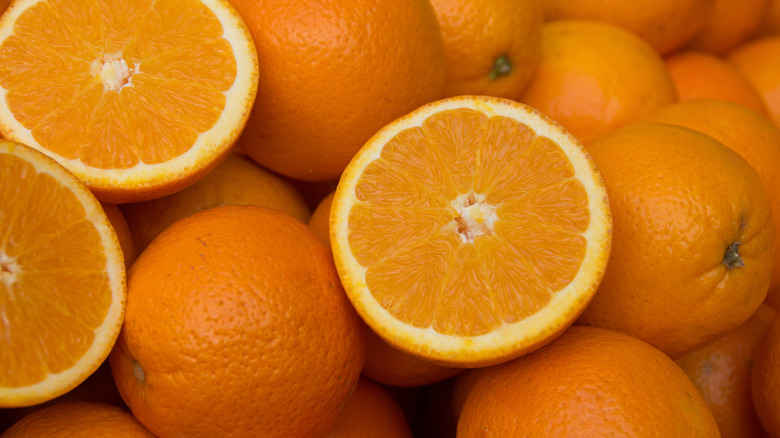 close up of navel oranges, with some cut in half