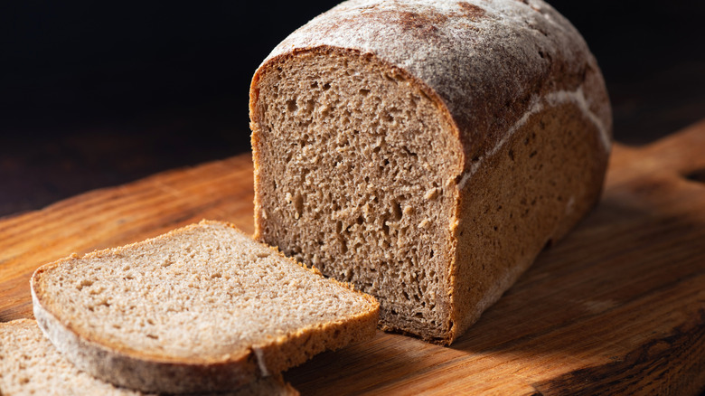 Loaf of artisan rye bread on wooden board