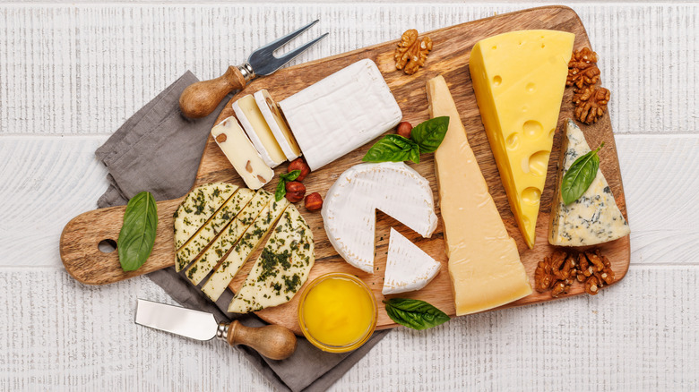 An assortment of various cheeses arranged on a board