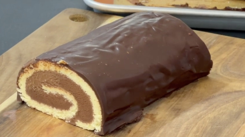 Chocolate Arctic roll on wooden serving board