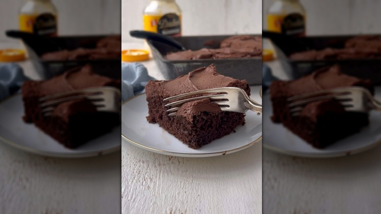 Fork digging into square slice of chocolate mayonnaise cake