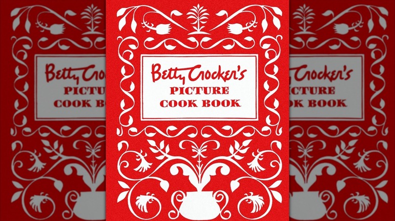 Mirrored image of vintage copy of Betty Crocker's Picture Cook Book against light grey background
