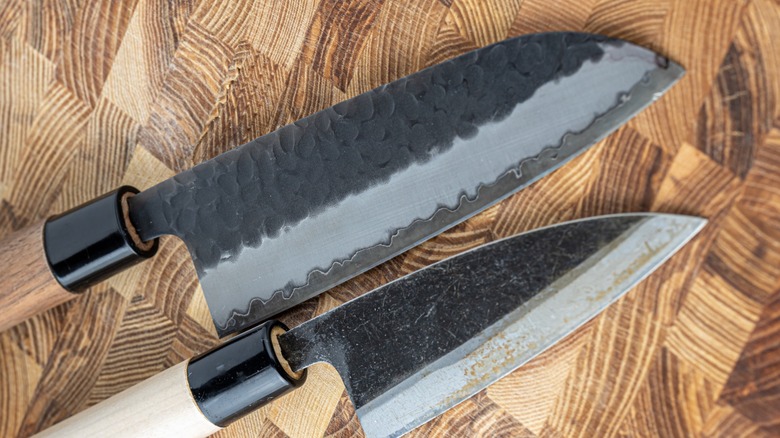 two carbon steel knives with patinas