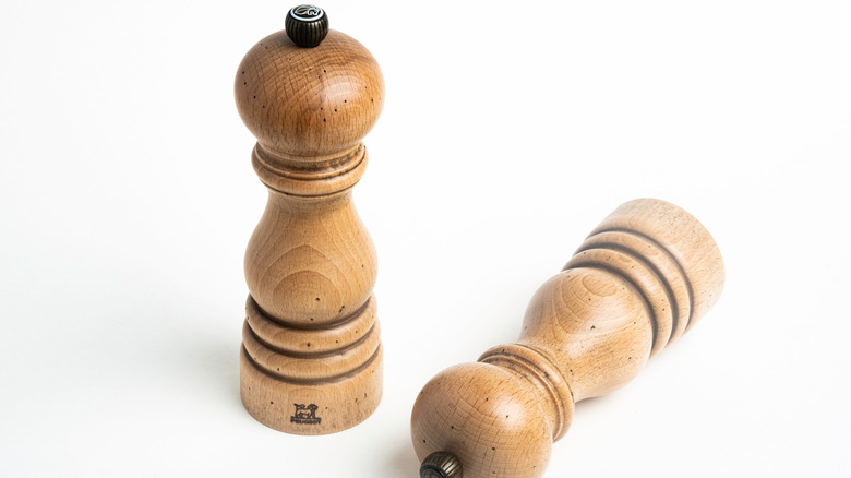 two peugeot pepper mills on a white background
