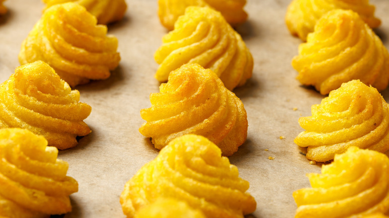 Rows of golden duchess potatoes