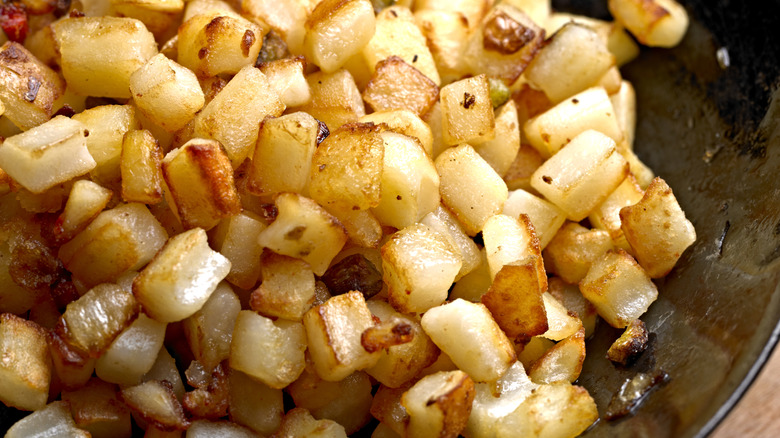 Potatoes O'Brien cooking in a pan