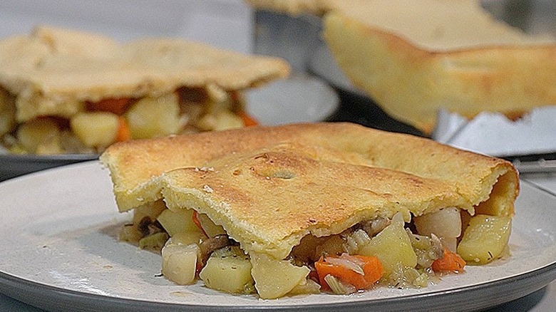 close up of slice of Lord Woolton's Pie on a white dish