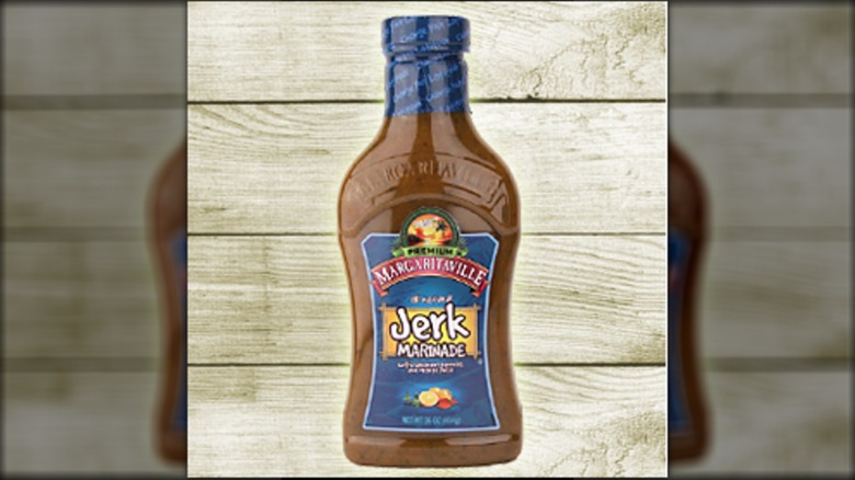 unopened bottle of Margaritaville Jerk marinade on wood panel background