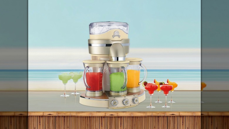 Margaritaville frozen drink maker and margarita glasses with beach background