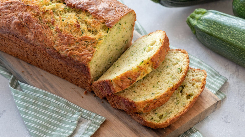 Sliced zucchini loaf on wooden cutting board