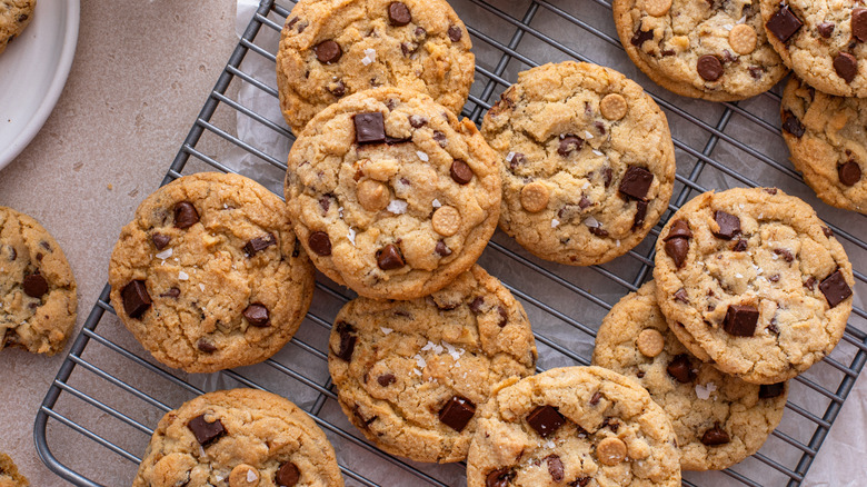 Freshly baked chocolate chip cookies on cooling rack