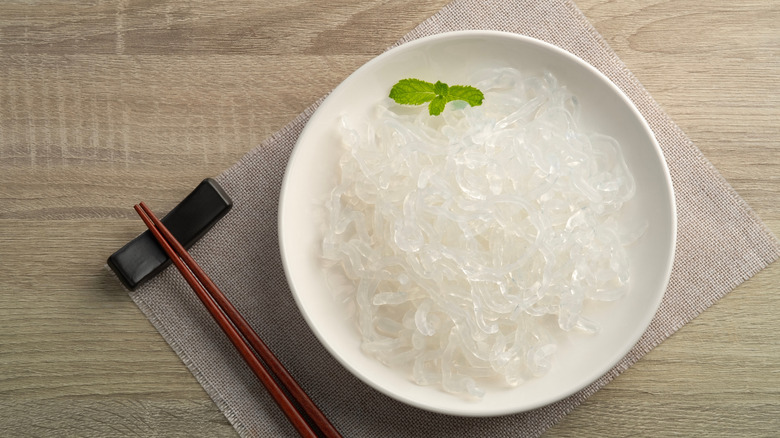 kelp noodles on a clean white bowl with chopsticks