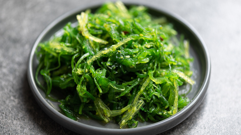 seaweed salad on a grey plate