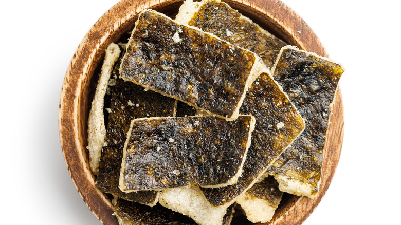 seaweed chips and rice paper in a wooden bowl