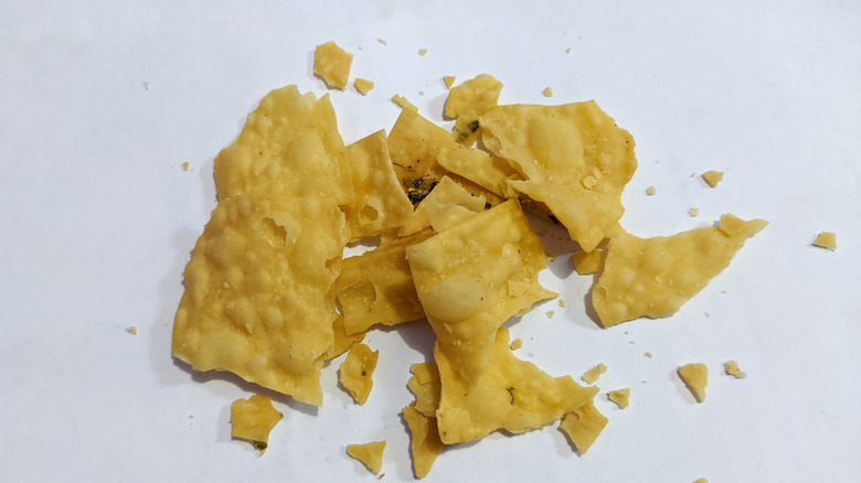 A few crushed chips on a white surface