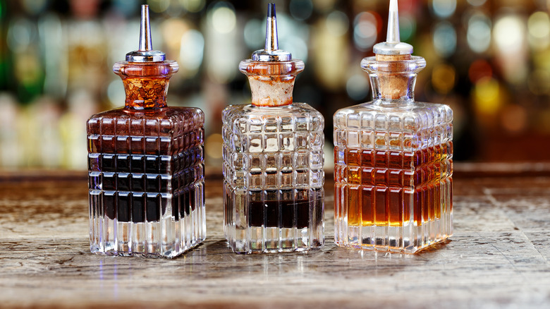 Three small bottles of cocktail bitters