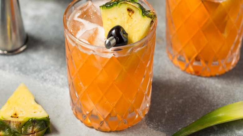 A rum-inspired drink with a pineapple garnish