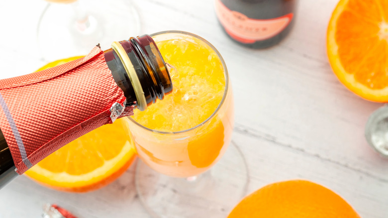 Non-alcoholic wine being poured into a mimosa