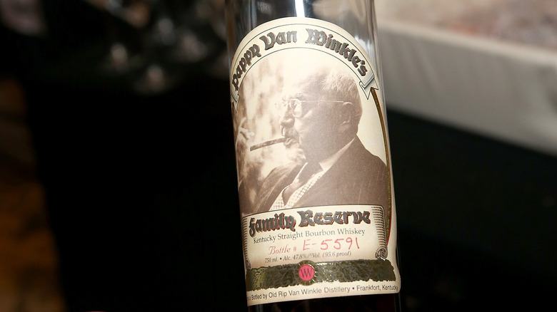 person holding a bottle of Pappy Van Winkle
