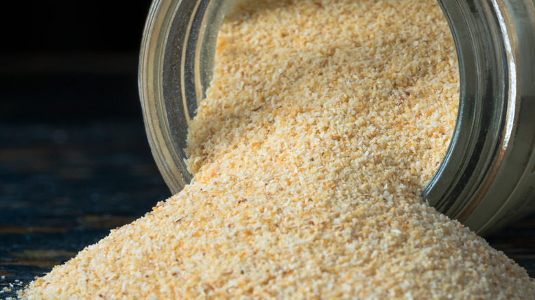 Close up of garlic powder spilling from spice jar