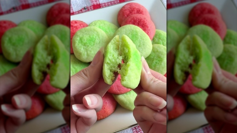 Hands breaking apart green Jell-O cookie