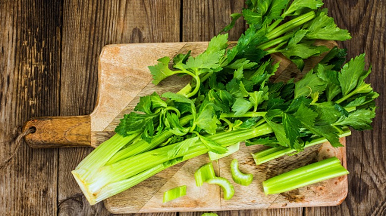 Celery leaves on cutting board