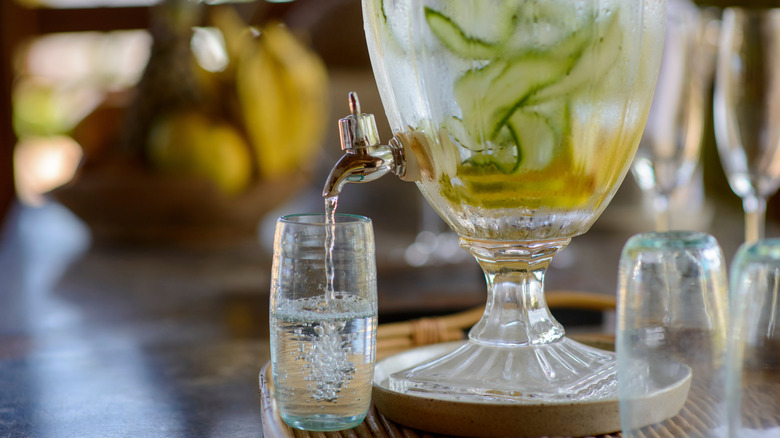 Infused water poured from a dispenser into a glass