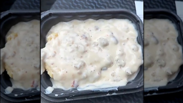 Wendy's biscuits and gravy in a black container