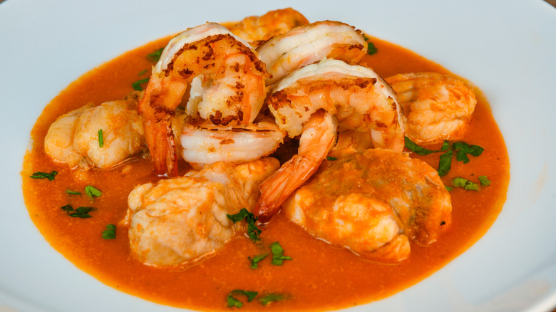 A Mediterranean dish of monkfish medallions and prawns served in a tomato-based sauce