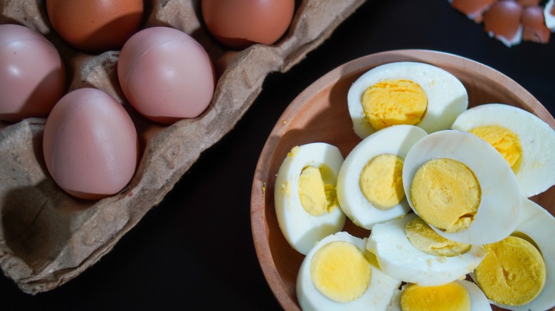 Hard boiled eggs cut in half in a wooden bowl