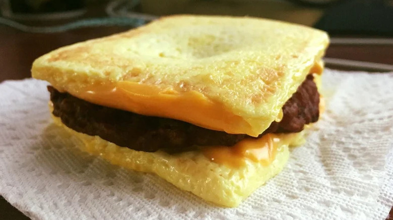 A breakfast sandwich with egg patty buns