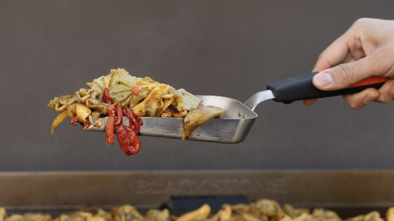 The Blackstone Griddle Scoop picks up a vegetable medley off the grill