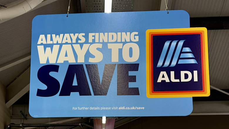 Blue sign hanging from ceiling in Aldi store
