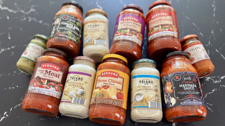 Various Aldi pasta sauce jars on countertop