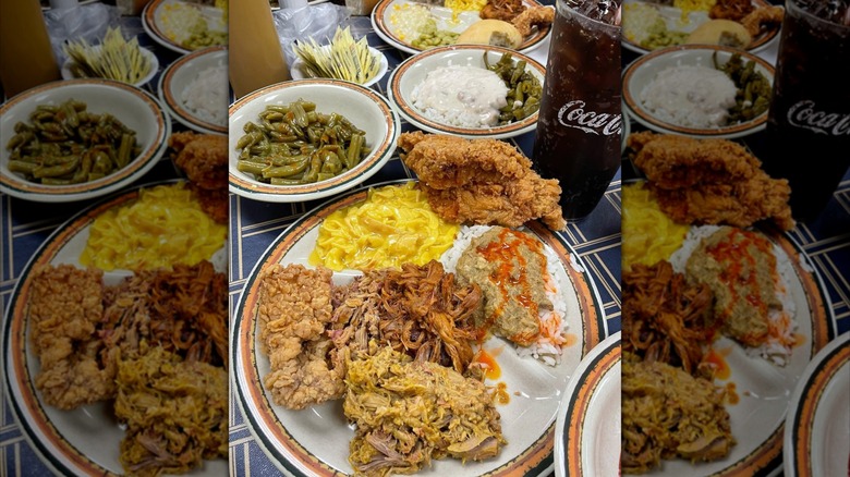 A plate of barbecue from Shealy's with a glass of soda and a few sides