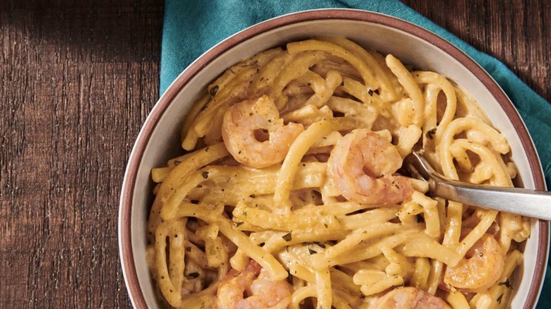 Bowl of Zatarain's Shrimp Alfredo served atop a napkin on a wooden table
