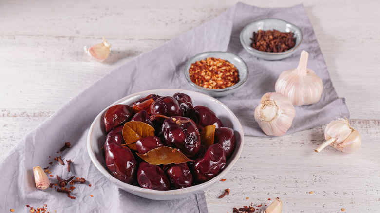 Prunes in a bowl with garlic and hot pepper