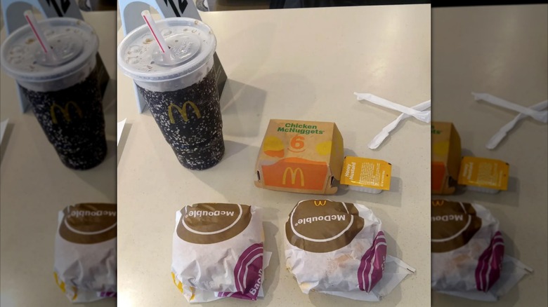 Large soft drink, 6-piece McNuggets box, and two burgers with a cup of honey mustard