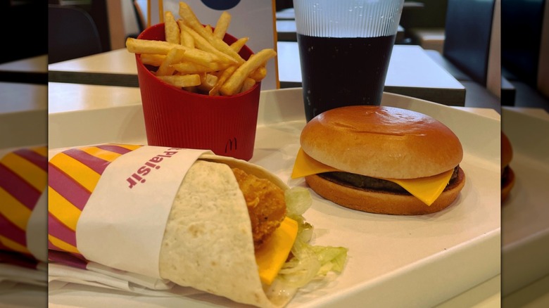 Cheeseburger and a chicken wrap from McDonald's with an order number stand