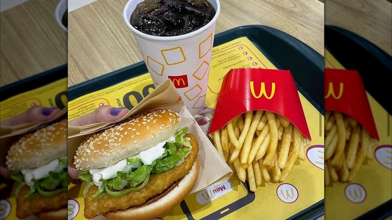 McChicken sandwich with a soft drink and medium fries resting on a tray