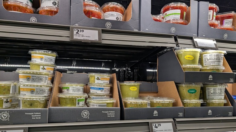 Salsas and guacamoles in the deli case at Aldi