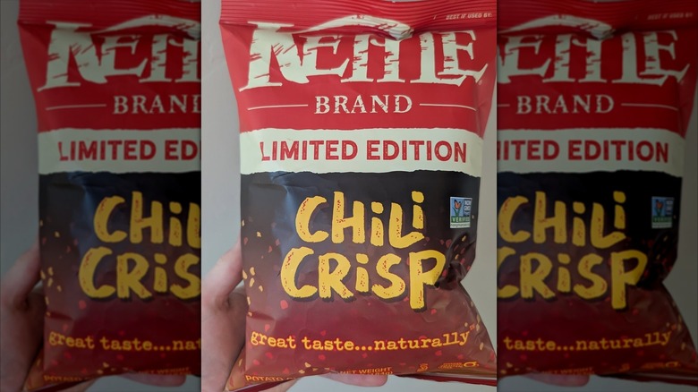 Hand holding a limited edition package of Kettle's Chili Crisp