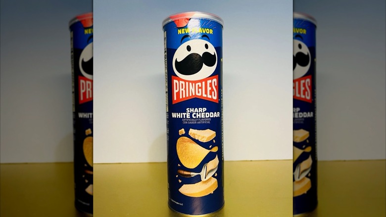 A signature Pringles tall can of Sharp White Cheddar chips
