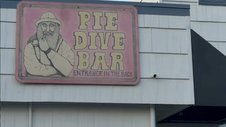 Pie Dive Bar pink sign on a white shingled restaurant exterior