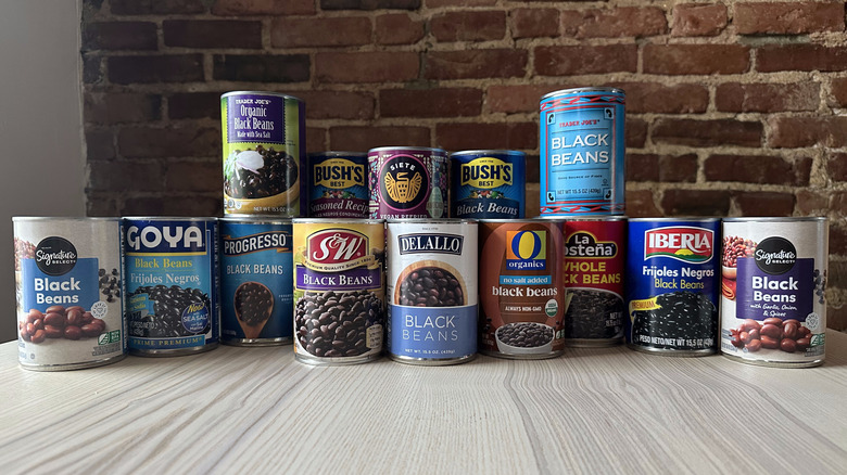 Cans of black beans on wooden table