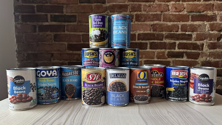 Cans of black beans on wooden table