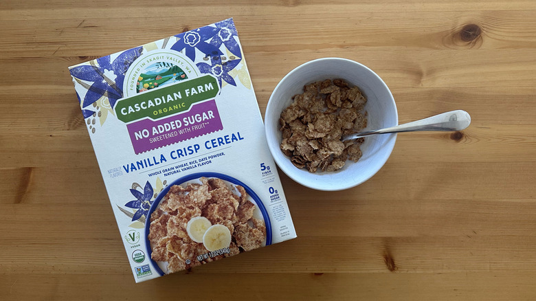 Top-view image of a box and a bowl filled with No Sugar Added Vanilla Crisp Cereal by Cascadian Farm on a table